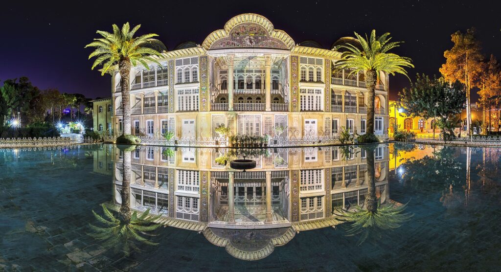 The pavilion of Eram Garden in Shiraz, lit at night and reflected in its pool